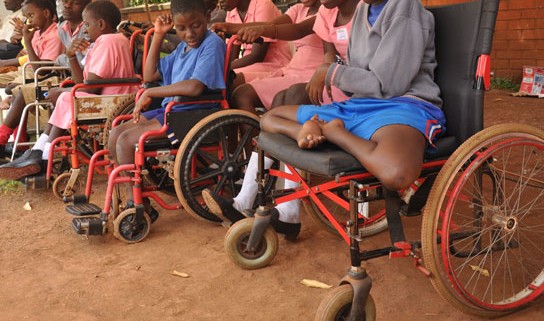 Reps spokesman provides prosthetic limbs, cash for 131 PWDs, seeks enforcement of law giving them access to public buildings
